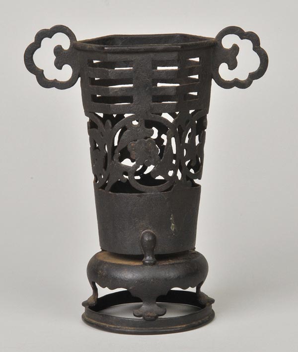 * An early Chinese bronze hexagonal vase, with twin scroll handle, and pierced and foliate scroll