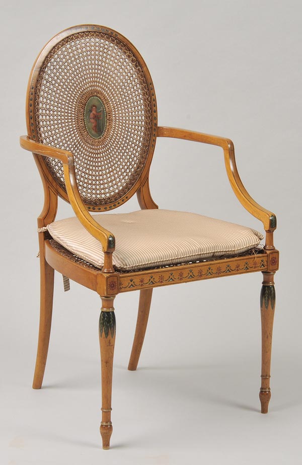 * An early 20th century armchair in the Neo Classical style, the oval caned back centrally painted