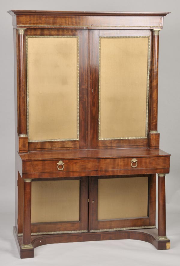 A Victorian Empire-style mahogany bookcase, the rectangular ogee cornice over twin covered doors