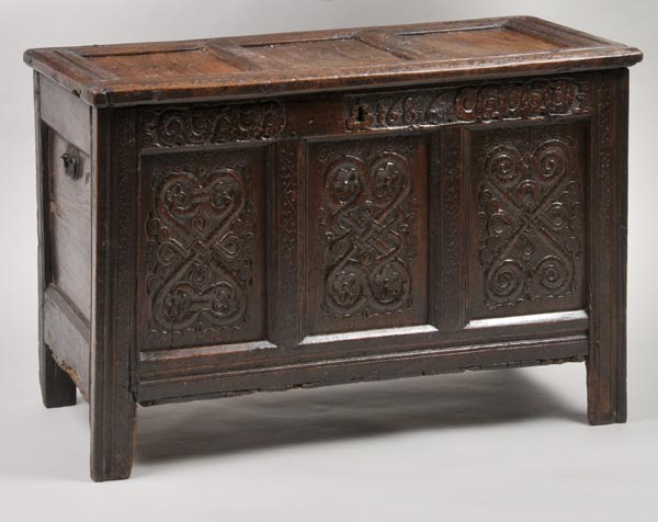 * An oak coffer, late 17th/early 18th century, the three-panelled lid over three-panel front, each