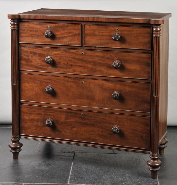 * A Victorian mahogany chest of two short and three long drawers with fluted columns, shaped