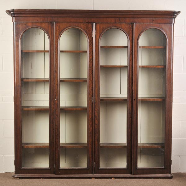 * A Victorian mahogany bookcase, the ogee cornice over four glazed doors each with arched mahogany