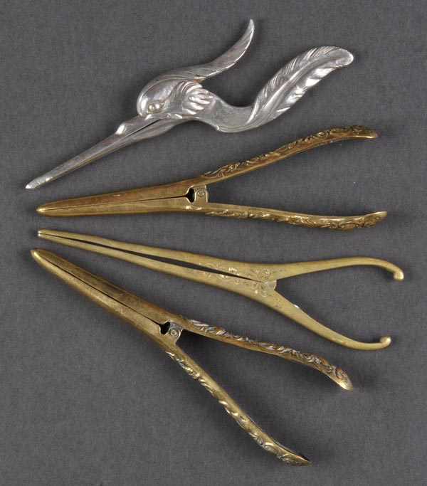 * A Chinese silver coloured metal glove stretchers, modelled as crane, with assay mark, 18cm long