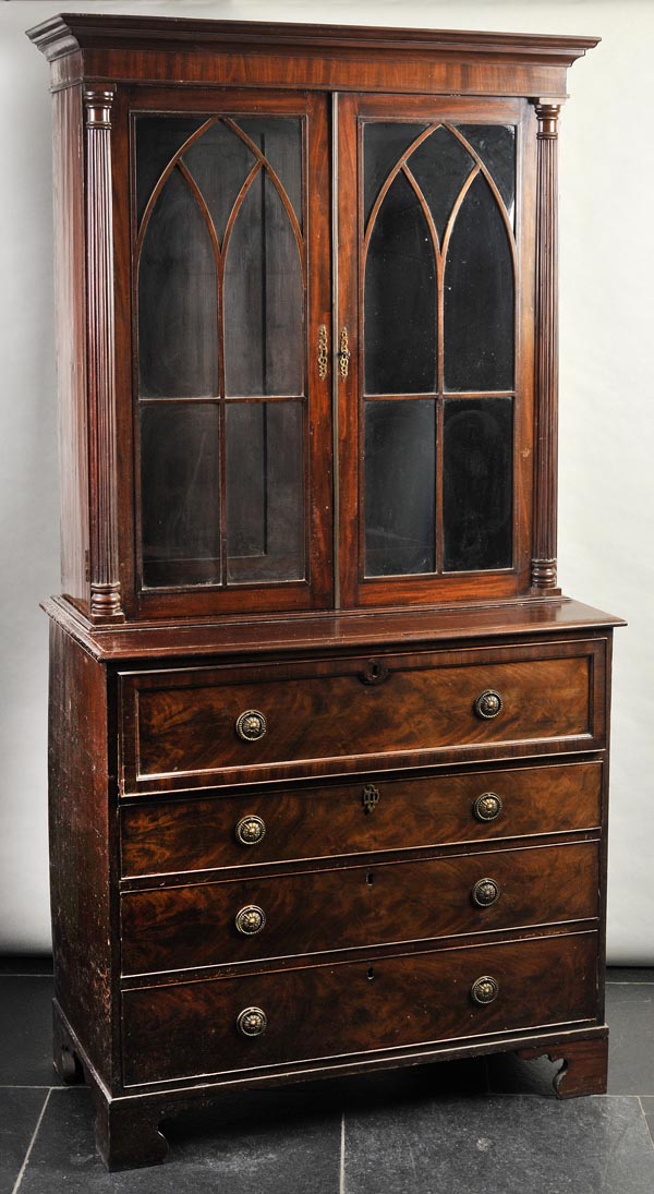 * A George III mahogany secretaire bookcase, the stepped cornice over twin glazed doors, each with