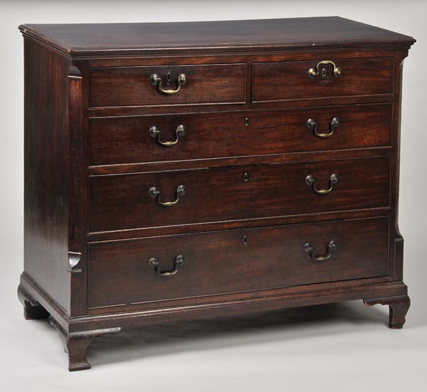 * A George III mahogany straight front chest of two short and three long drawers, with rosewood