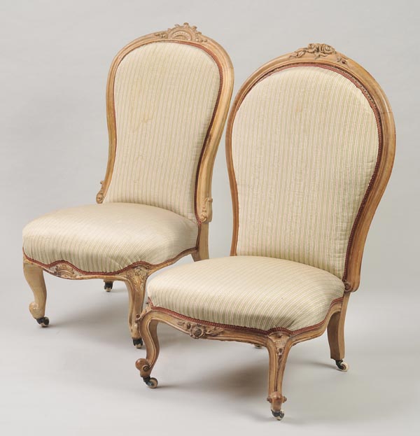 * A matched pair of Victorian bedroom chairs, each with beech carved showframe, striped upholstery