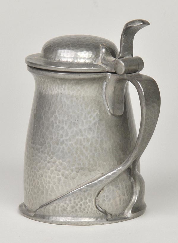 * A Liberty Tudric lidded jug in the manner of Archibald Knox, hammered finish and stylised Art