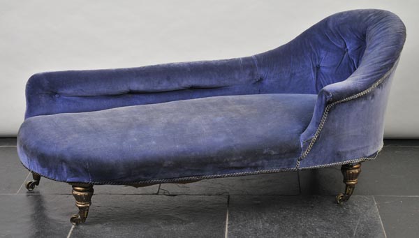 * A Victorian button upholstered chaise longue, covered in blue velvet over four giltwood supports