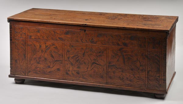 * A Continental hardwood coffer, probably 19th century, the hinged rectangular top over carved front