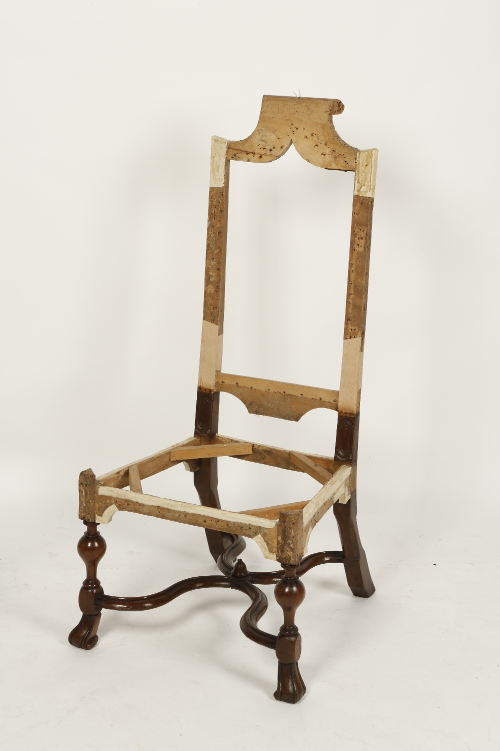 A QUEEN ANNE WALNUT HIGH-BACKED CHAIR FRAME, with a scrolling top rail above an open back and