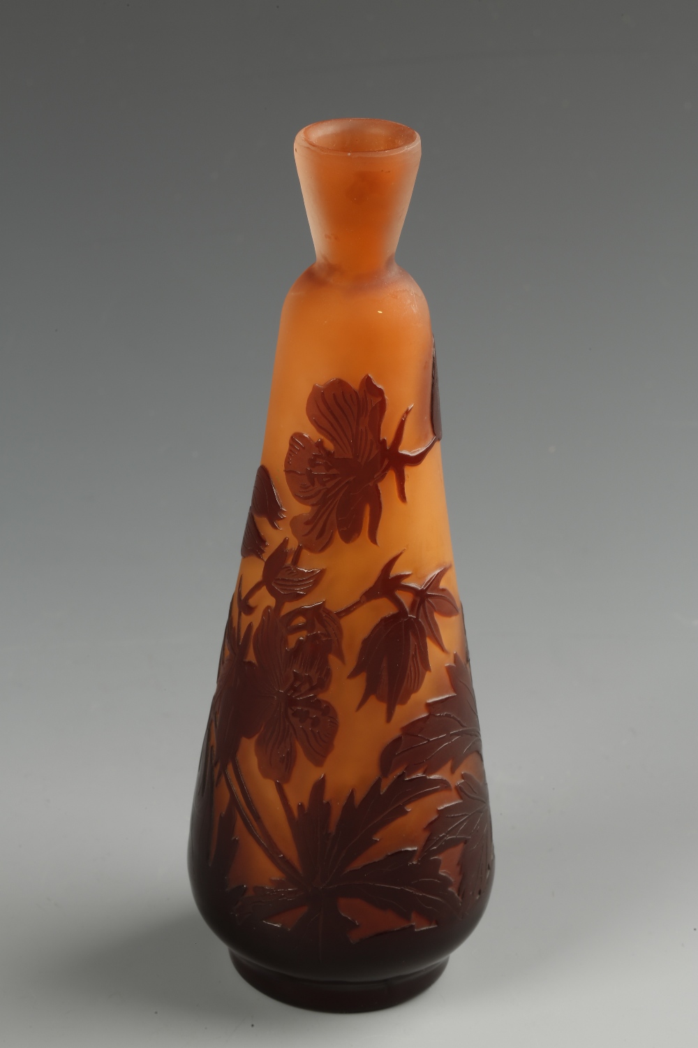 GALLE: A SLENDER TAPERING CAMEO GLASS VASE with flared neck and raised floral and foliate