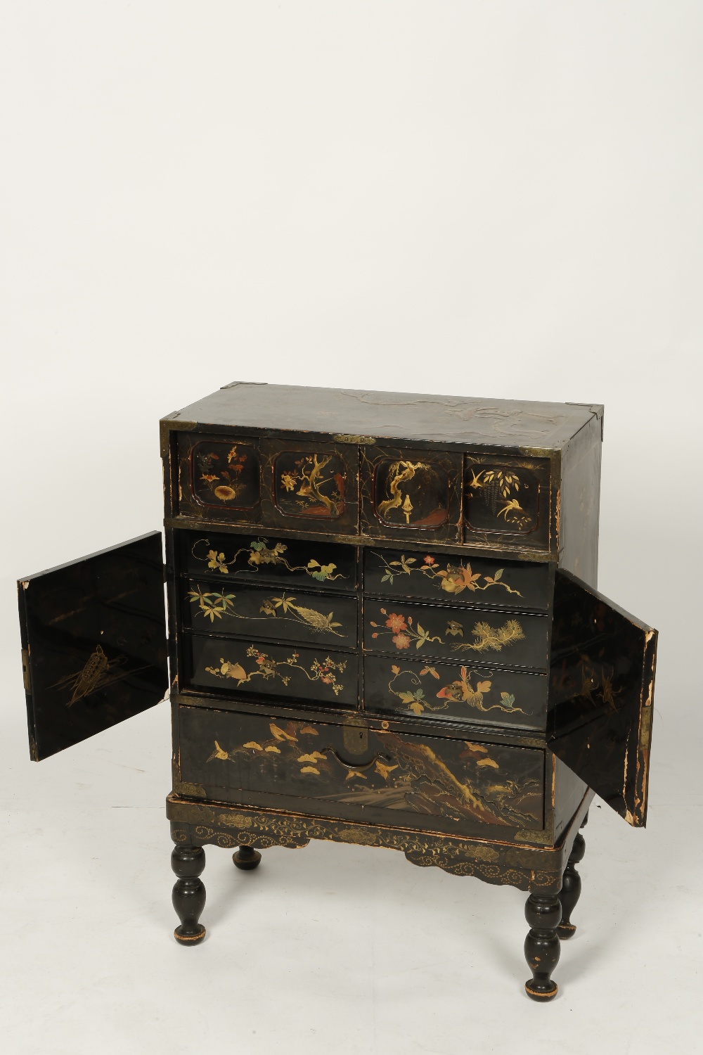 A CHINESE BLACK AND GILT LACQUERED CABINET ON STAND, with all over red and gilt lacquer, with