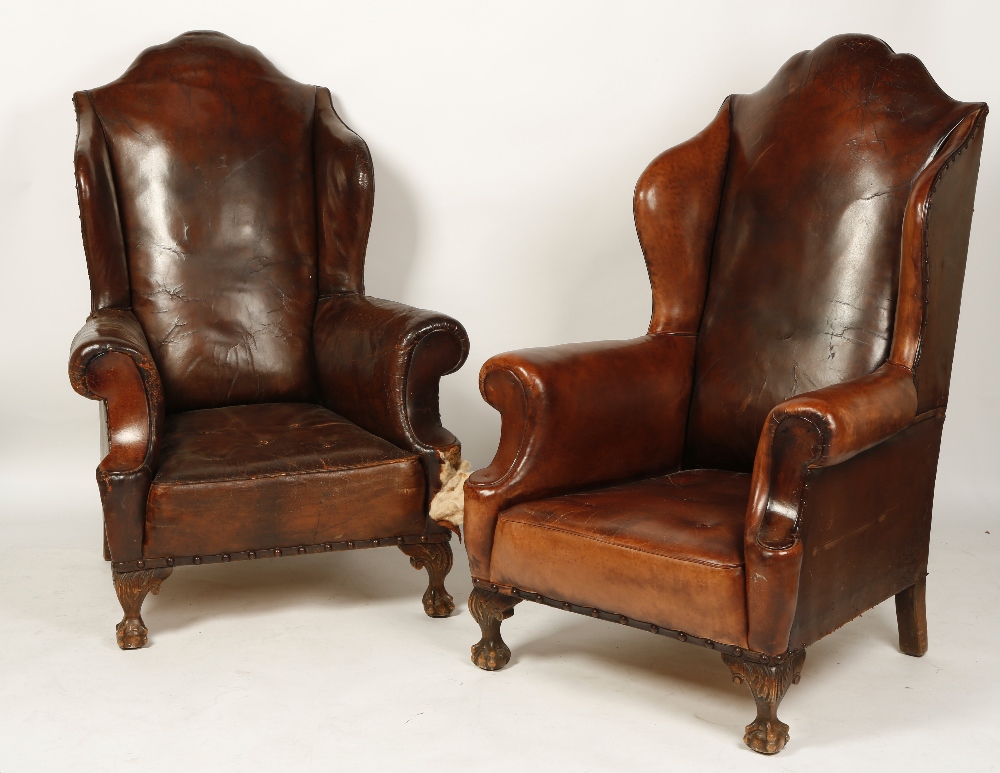 A PAIR OF QUEEN ANNE STYLE LEATHER UPHOLSTERED WING-BACKED ARMCHAIRS, the tall arched backs above