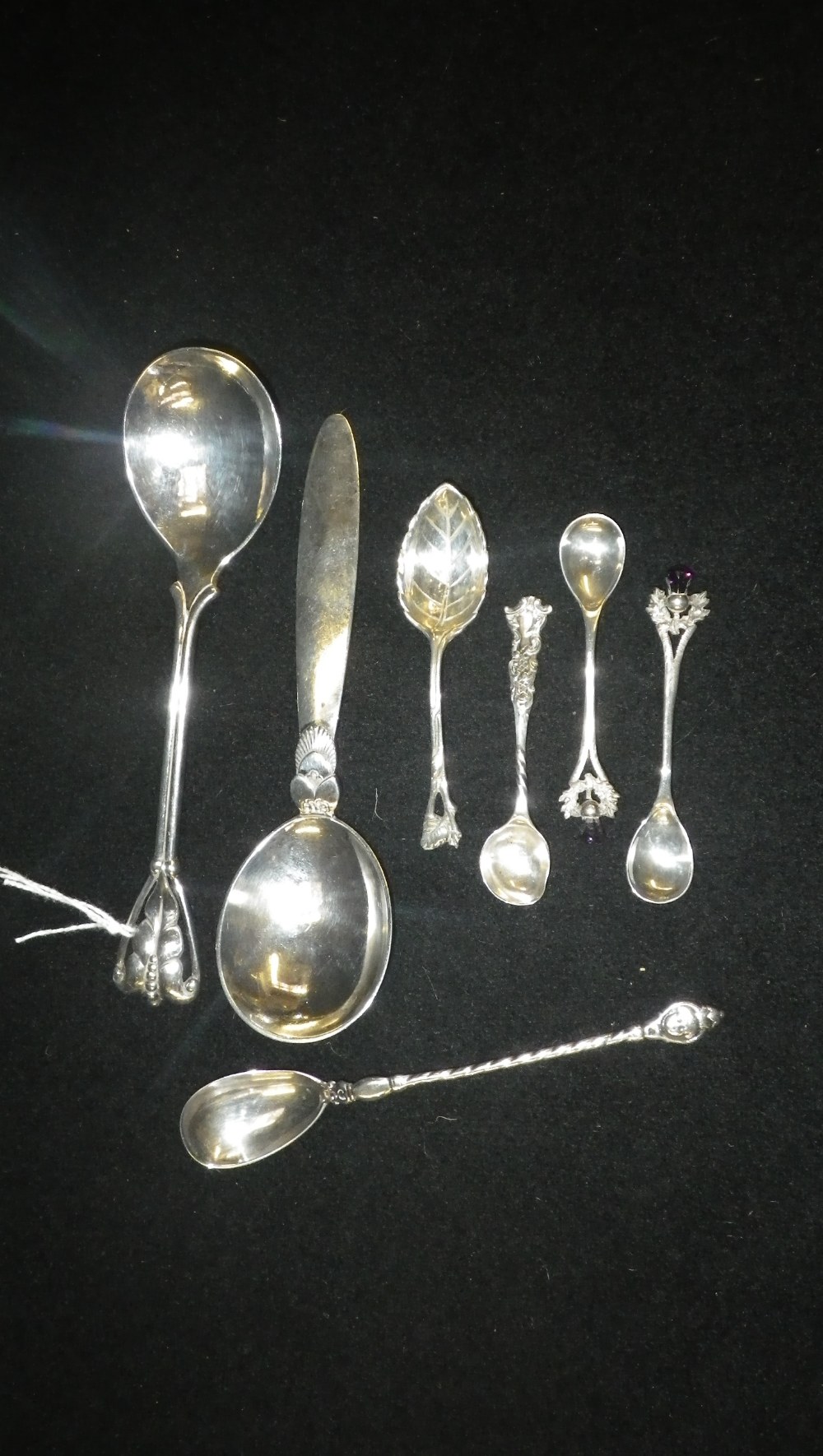 An Art Deco style Continental silver spoon another similar and a quantity of other further spoons