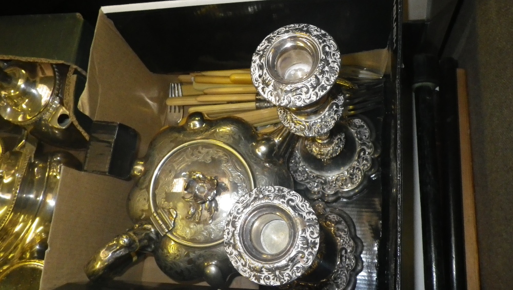 A small quantity of plated wares including a pair of candlesticks, teapot and other similar items