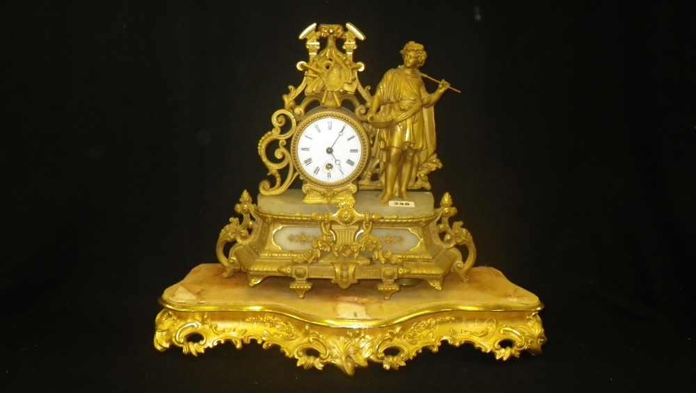 A 19th century French gilt spelter mantel clock on a giltwood stand