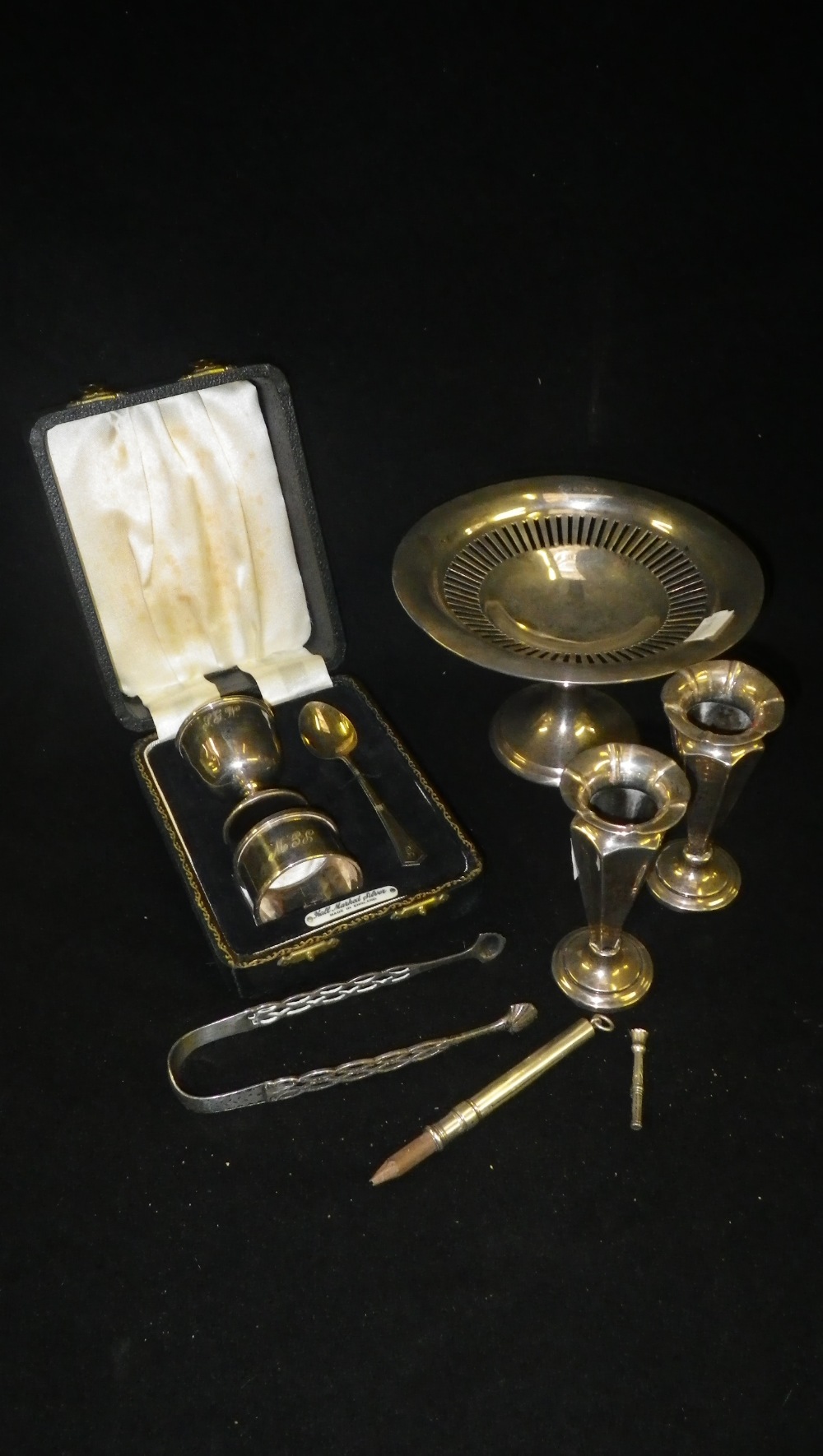 A Birmingham silver pedestal dish, a silver egg cup spoon and napkin ring cased set and other