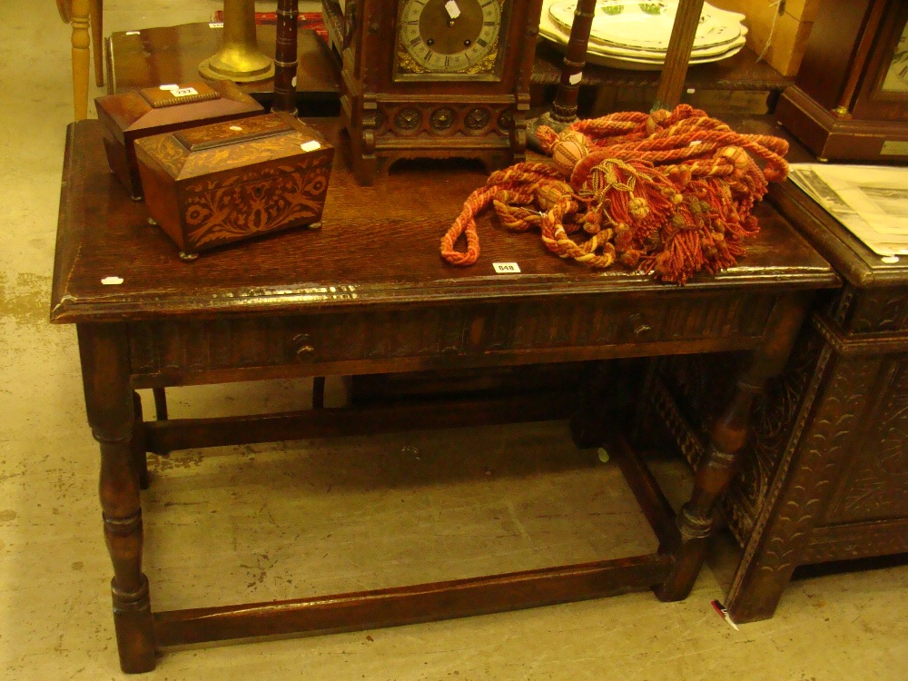 A reproduction oak side table with carved decoration