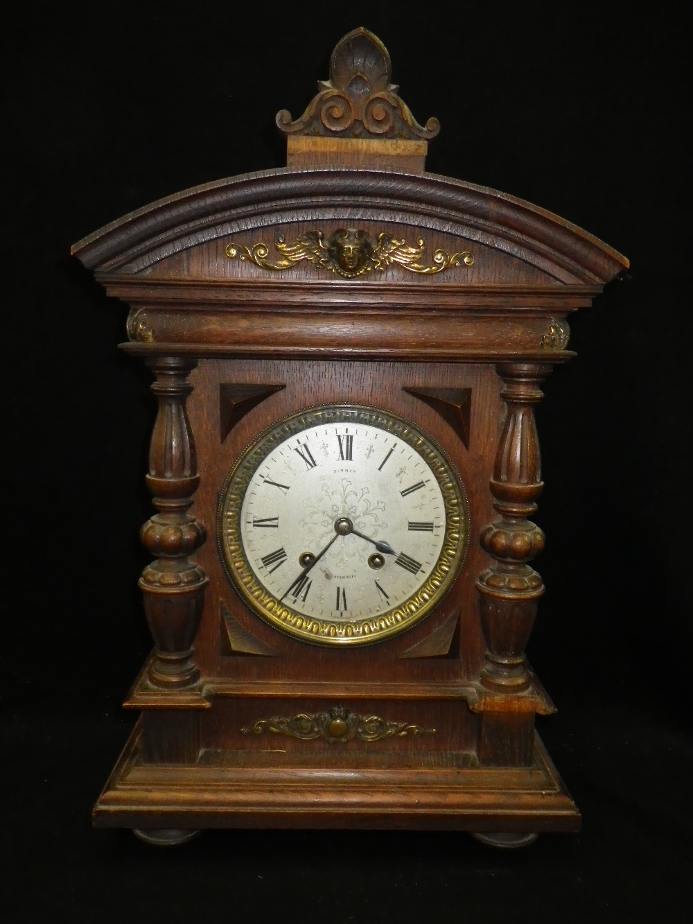 A 19th century oak-cased mantel clock inscribed `Dimmer, Portsmouth`