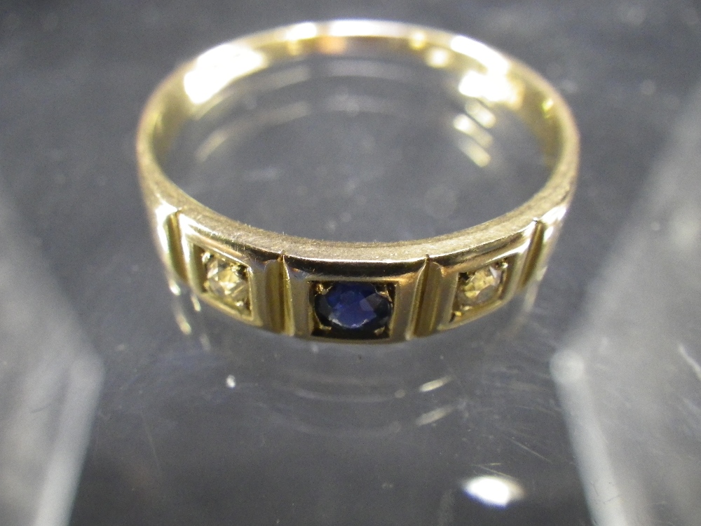 A sapphire and diamond gypsy set ring