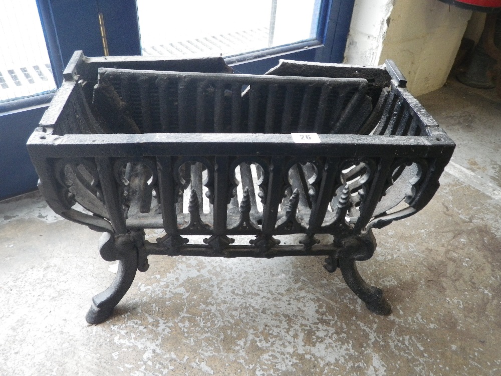 A 19th century iron fire basket with hoof-shaped feet