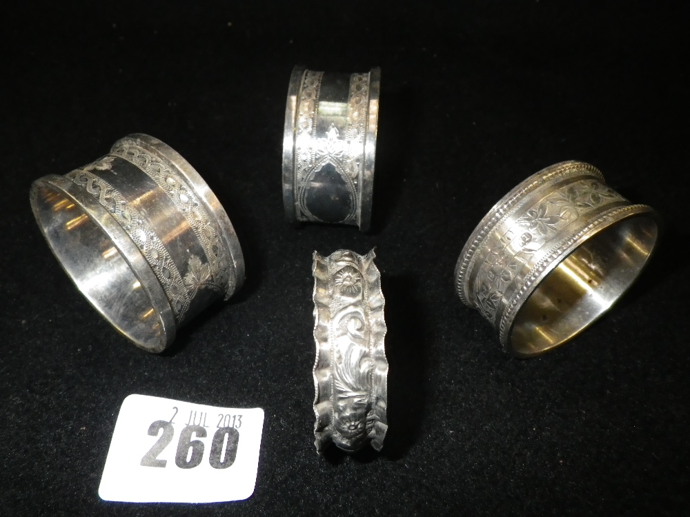 A pair of engraved silver napkin rings and two others