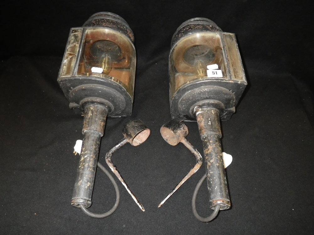 A pair of early 20th century carriage lamps with curved and bevelled glass
