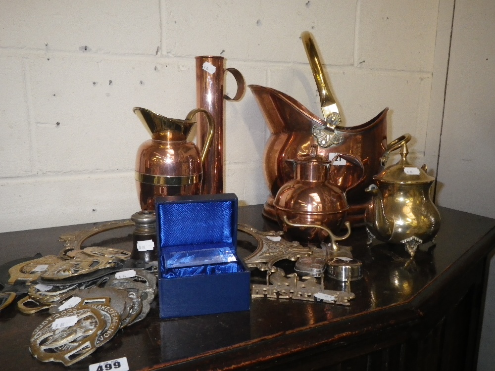 A collection of metalware including a coal scuttle, a Guernsey milk jug and a plated coin dispenser