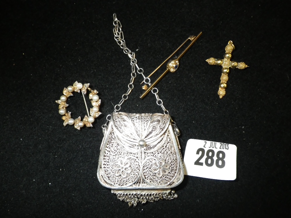 A white metal filigree chatelaine purse, a pearl and white stone wreath brooch and two other