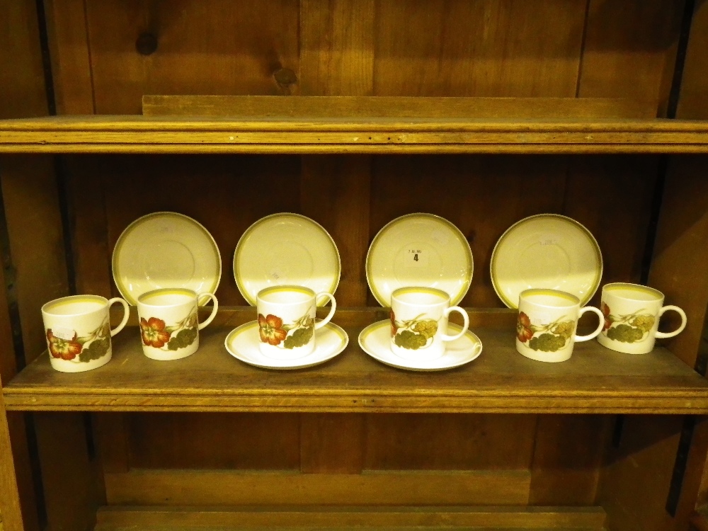 A set of six Susie Cooper `Nasturtium` pattern coffee cups and saucers