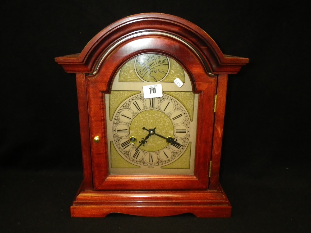 A red stained mantel clock by C Wood & Son