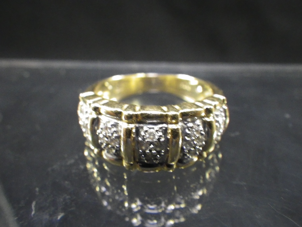 A 14ct yellow gold band set with diamond chip clusters