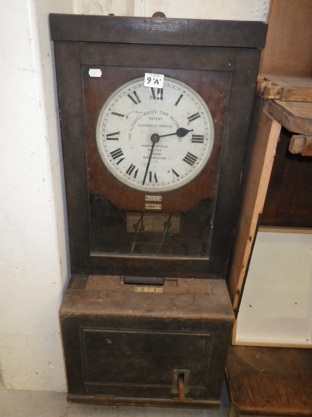 An oak-cased `Electrically Propelled Glendhill-Brook Time Recorder` (clocking-in clock)