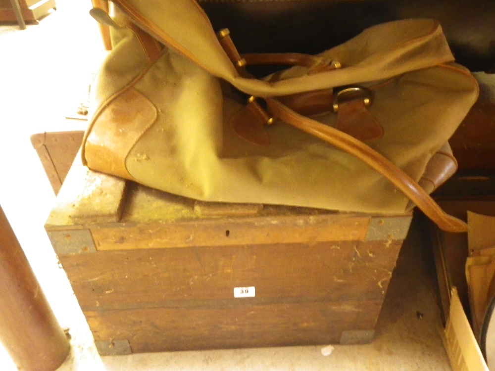 A collection of vintage luggage including a wooden bound trunk