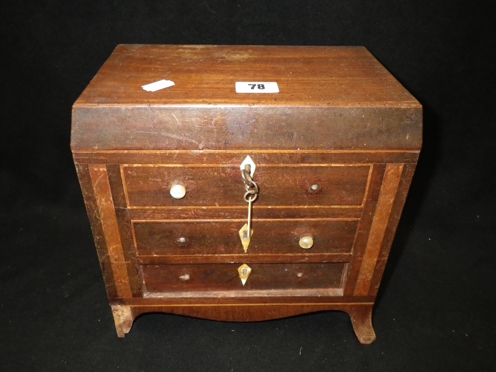 A 19th century mahogany workbox in the form of a miniature chest of drawers