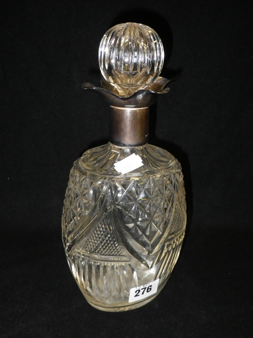 A silver mounted cut-glass decanter