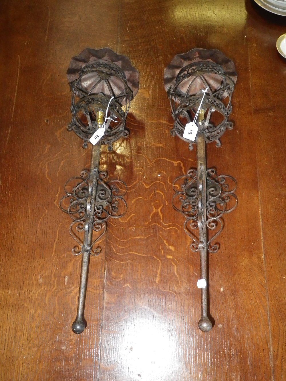 A pair of wrought-iron wall lights
