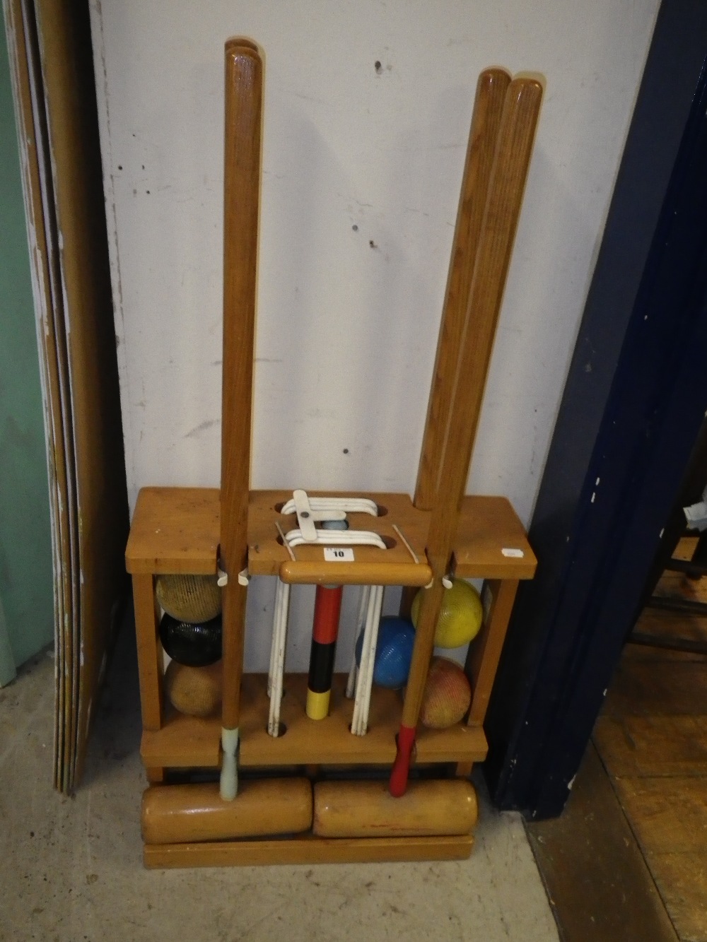 A vintage croquet set in a fitted beech stand