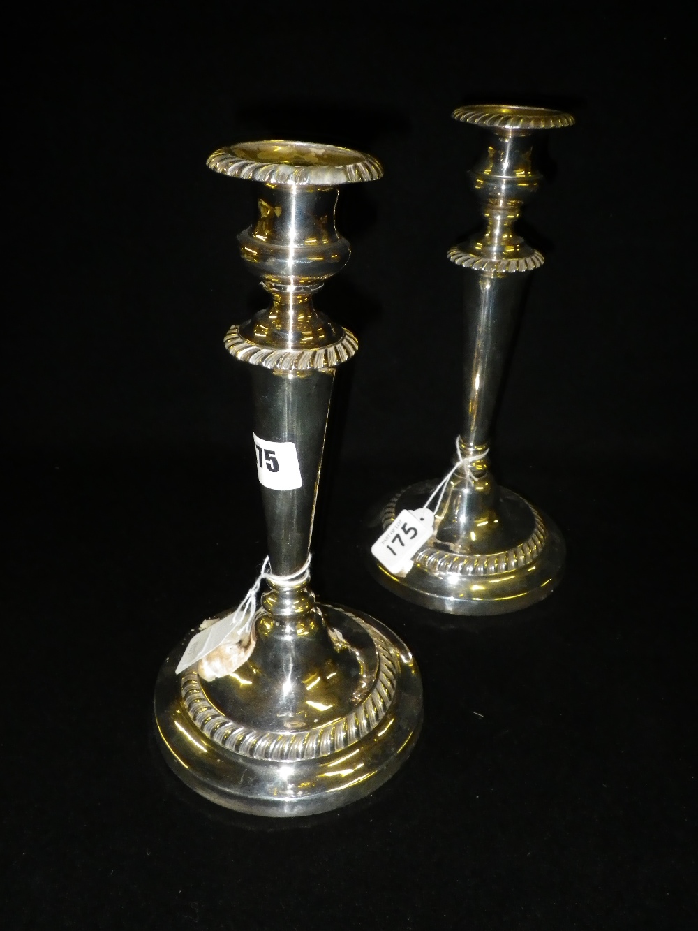 A pair of plated candlesticks, with circular bases