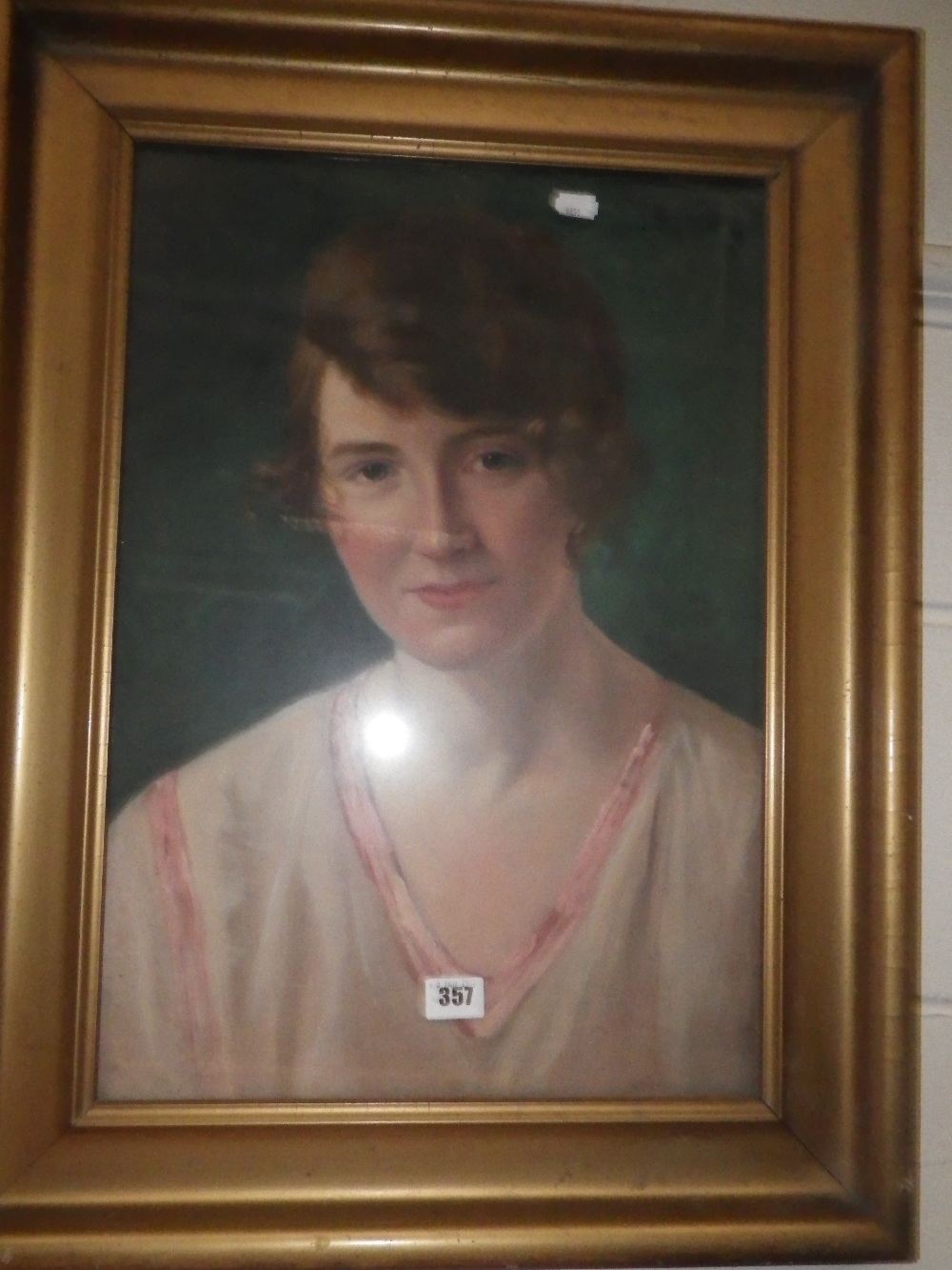 An early 20th century oil on board portrait of a lady, inscribed J B Walker