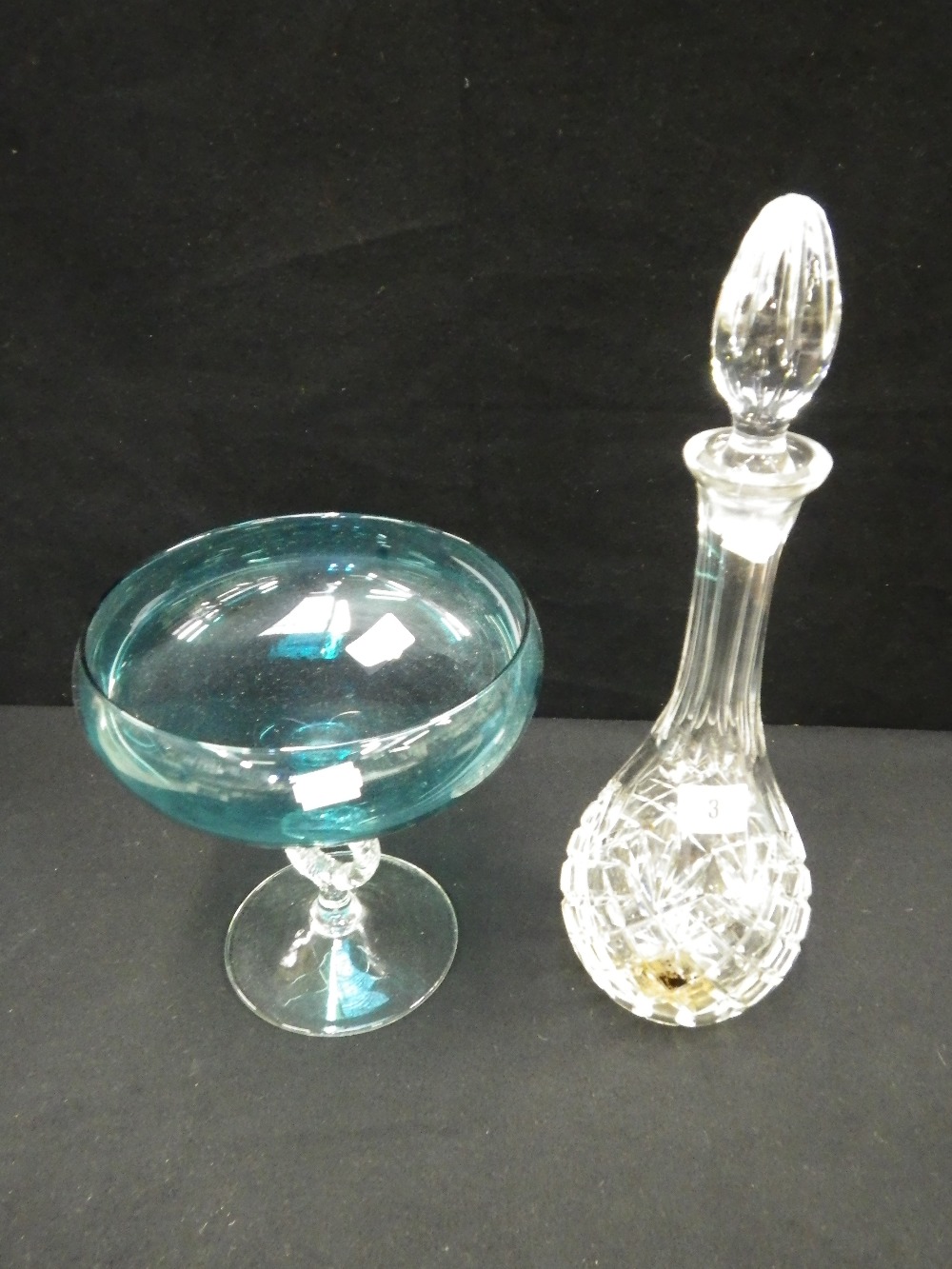 A cut-glass decanter and a green aquamarine footed bowl