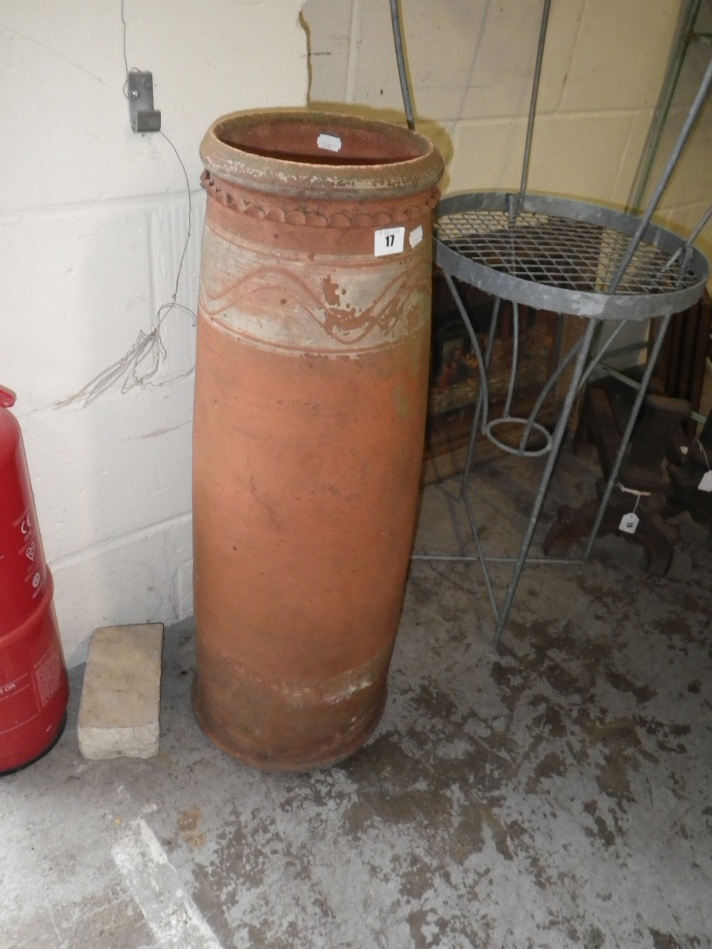 An early 20th century slip decorated terracotta chimney pot