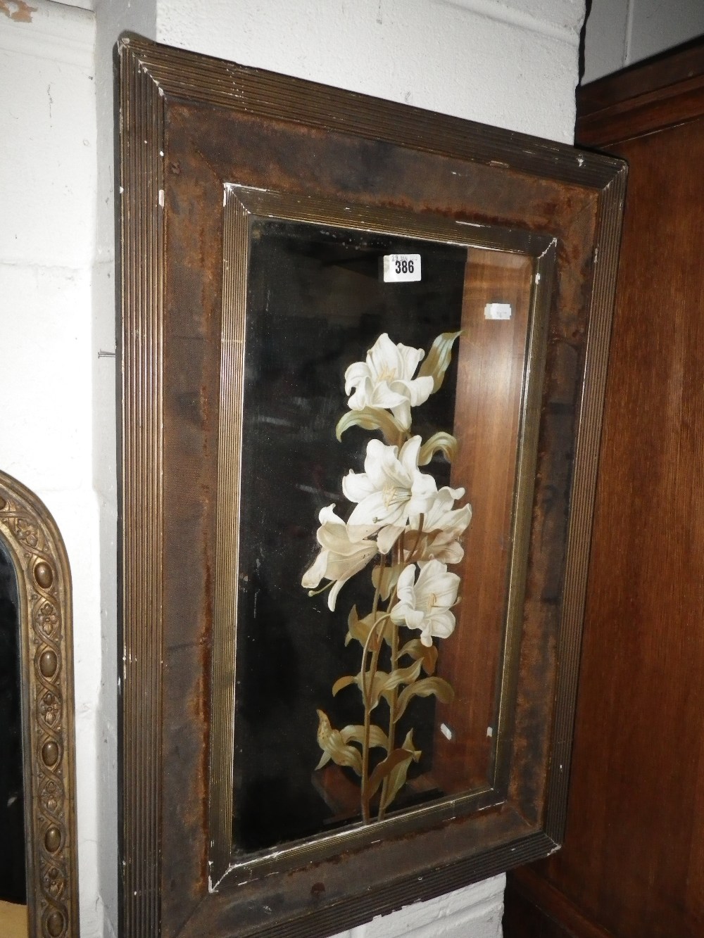 A pair of Victorian wall mirrors, reverse decorated with lilies