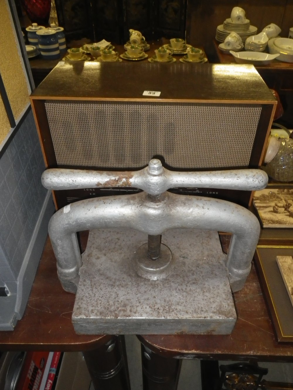 A cast-iron book press and a vintage walnut cased radio