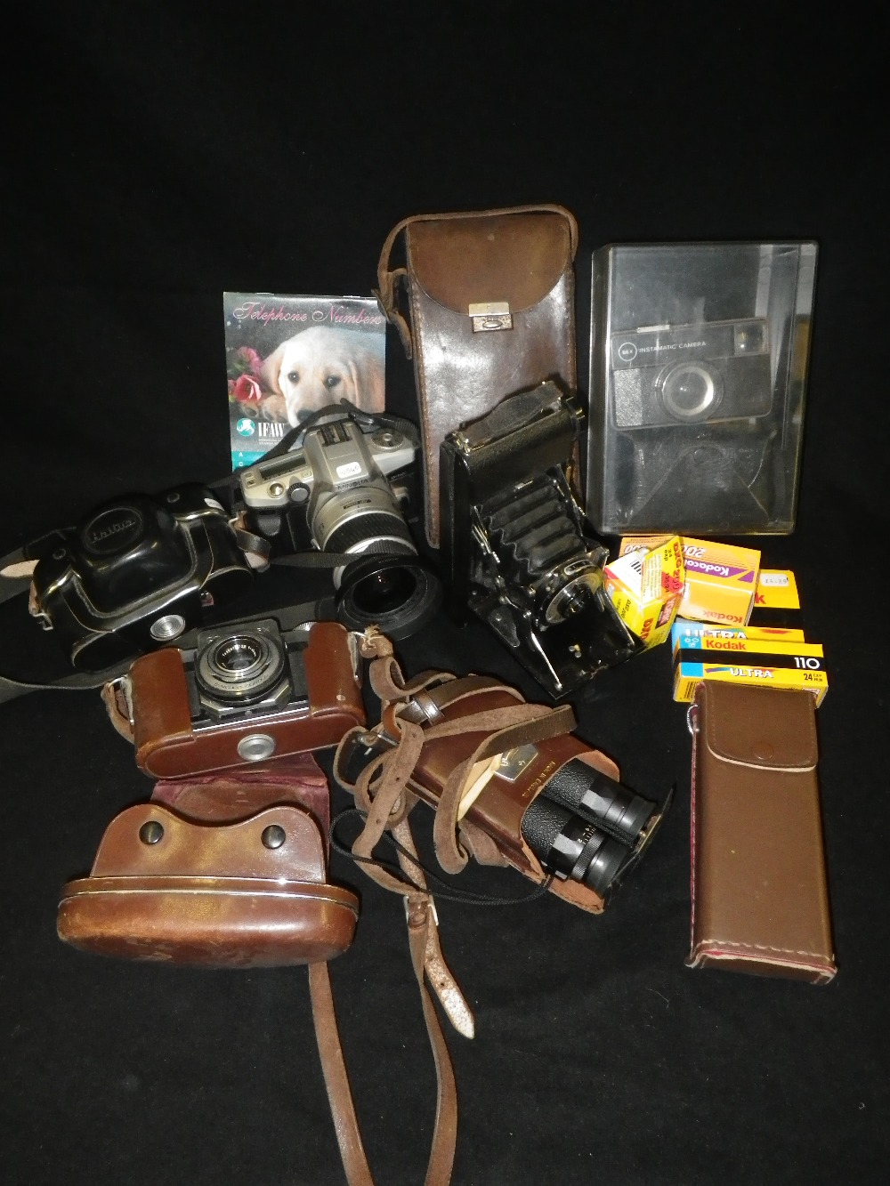 A Halina camera and a collection of cameras and accessories