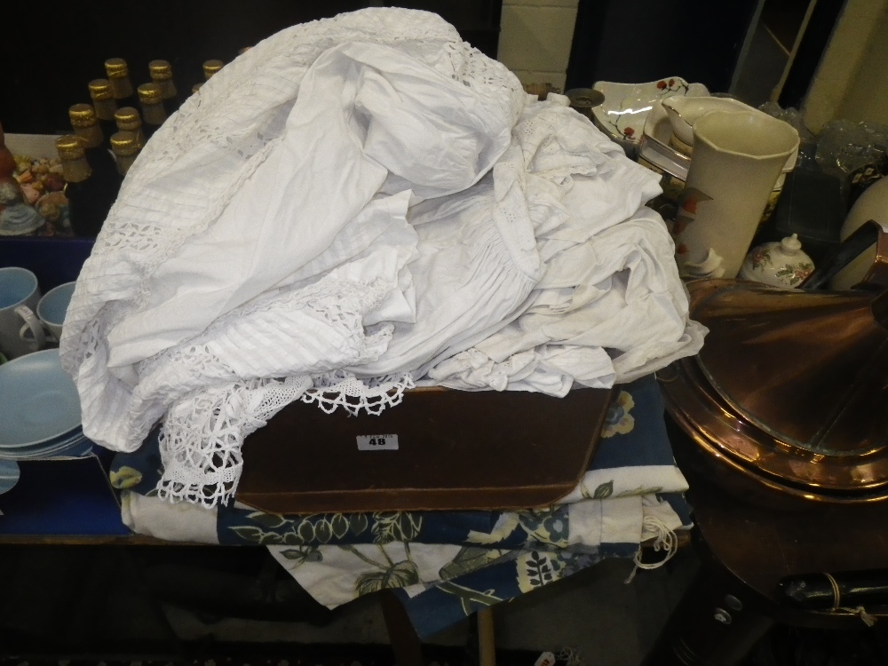 A collection of Edwardian and Victorian christening gowns and clothing and a quantity of curtains