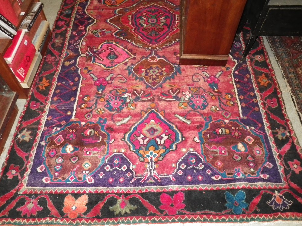 A red ground Persian Lori rug with overall floral decoration