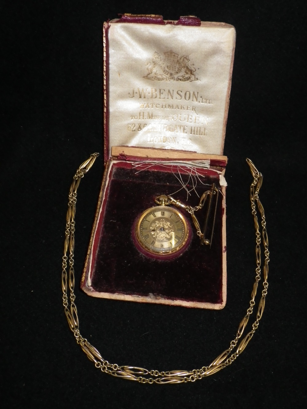 An 18ct yellow gold Benson`s ladies fob watch with brooch fitment and chain in original fitted case