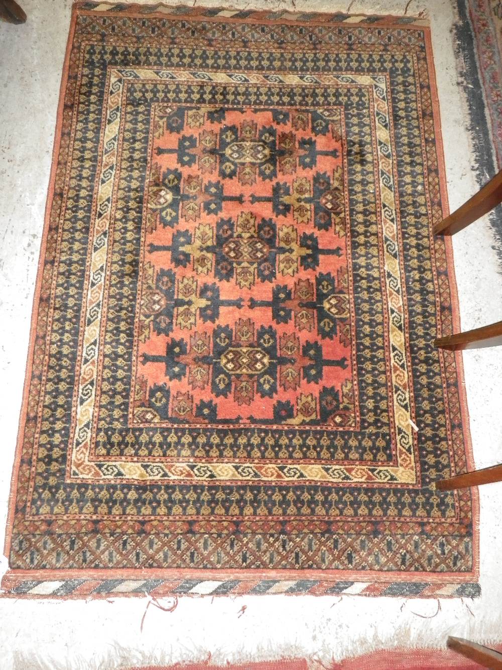A russet ground Persian rug with overall geometric decoration
