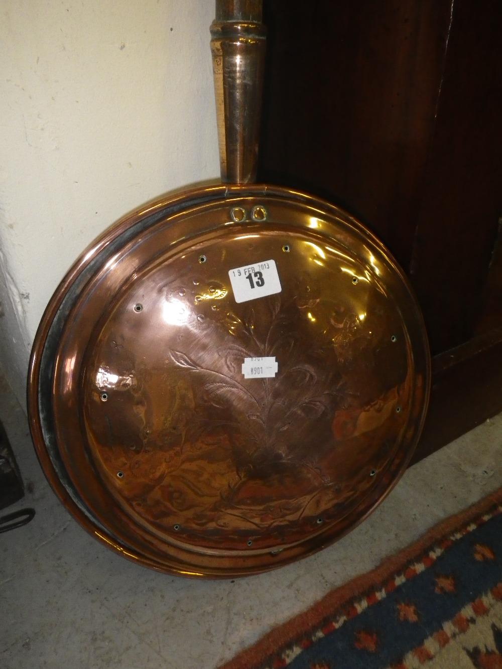 An early 19th century copper warming pan with very long handle